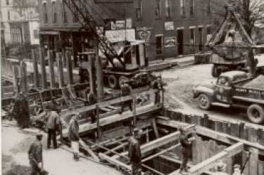 A crew works on a sewer in the 1940s